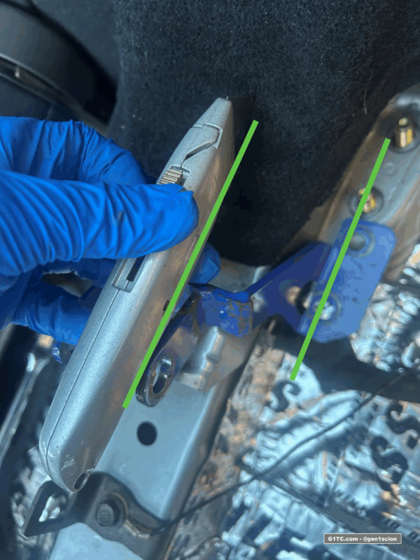 cutting slits in the carpet for the Greddy rear strut tower bar bracket