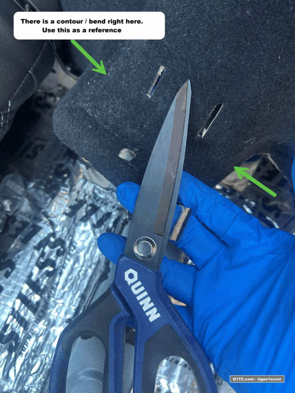 cutting slots in the carpet for the greddy rear tower bar bracket