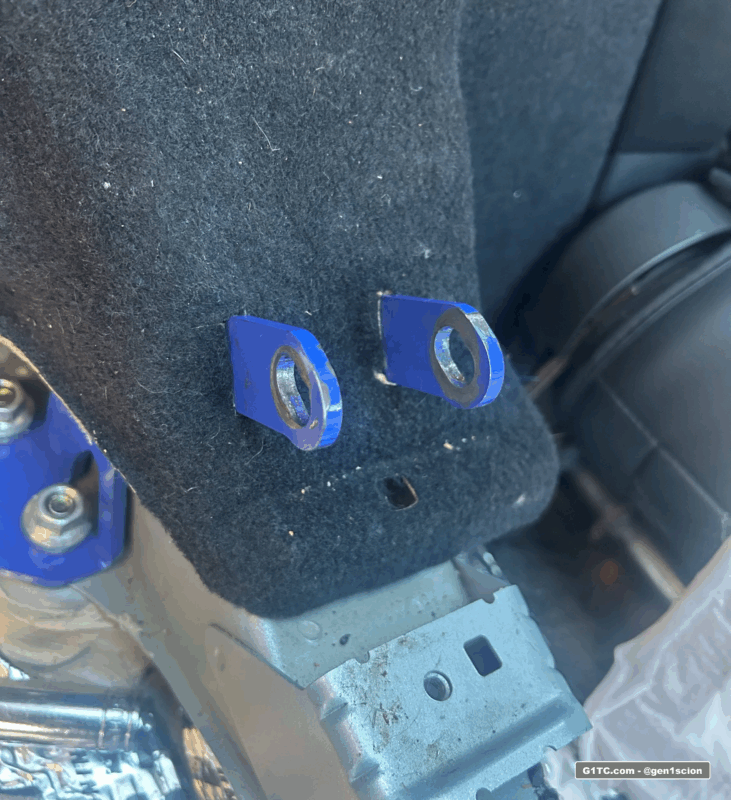 poke greddy bracket tabs through carpet for clean install