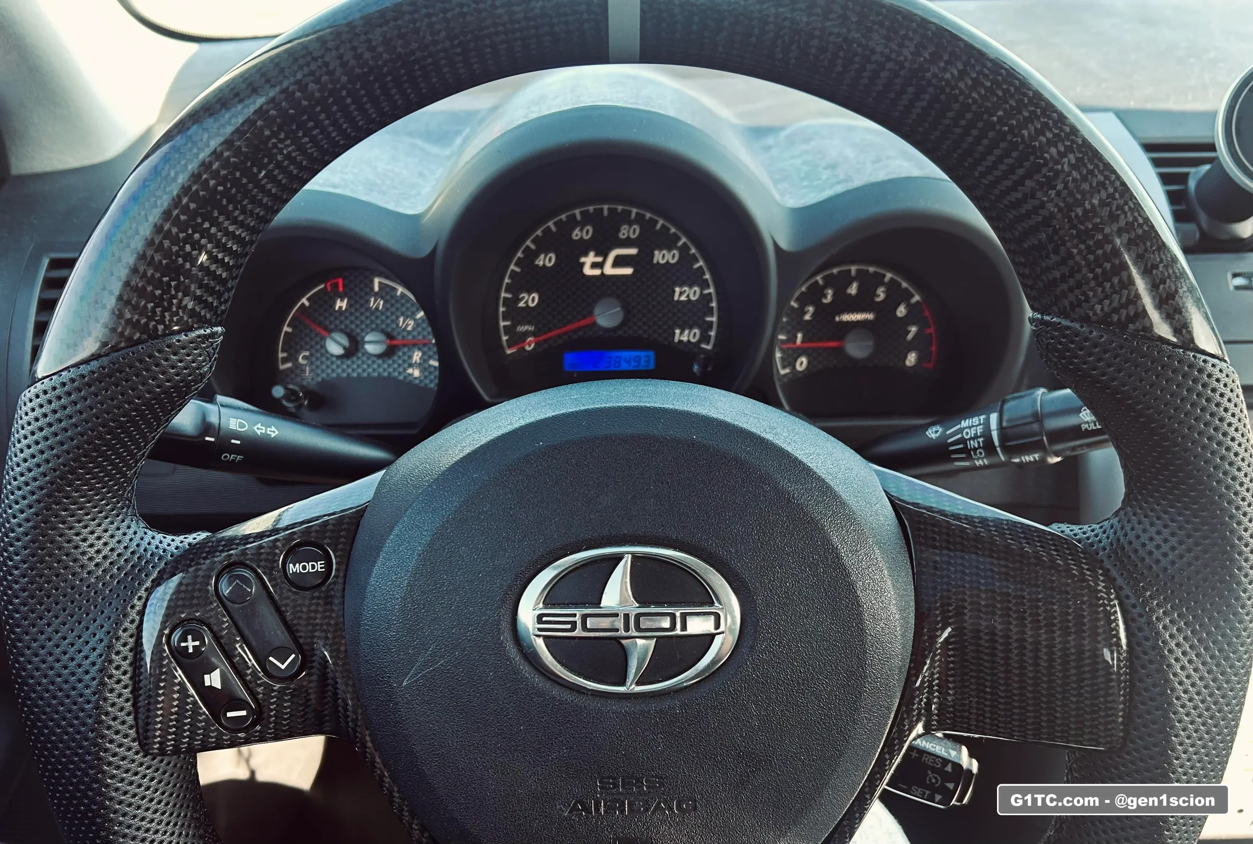 TC2 carbon fiber steering wheel with Black Cat Custom gauge face