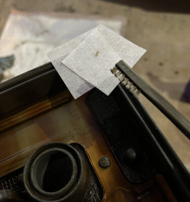 cleaning the valve cover channel with thin brush