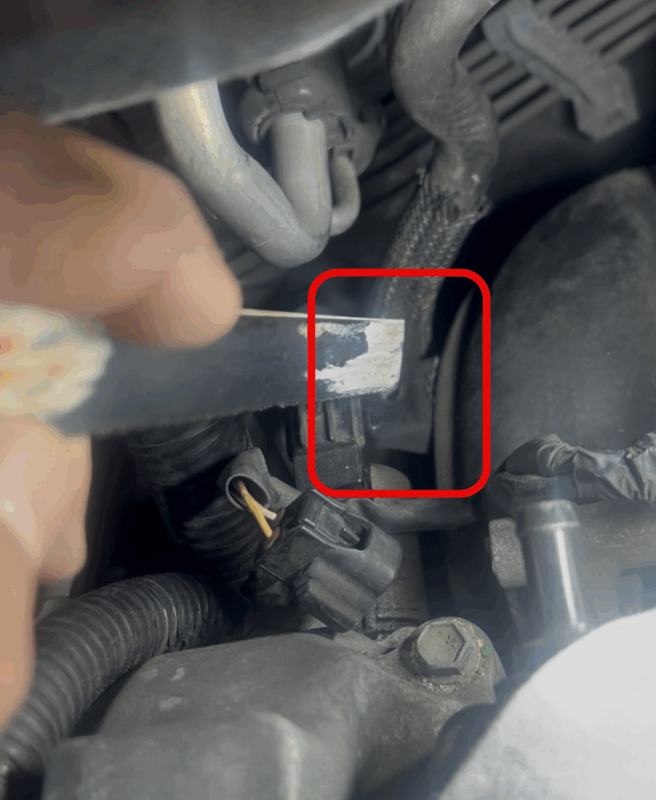 cut plastic tab off intake manifold to make clearance using a saw blade by hand